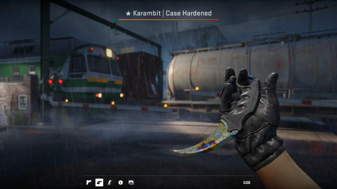 Karambit Case Hardened Blue Gem knife inspect view against a rainy urban CS2 map background